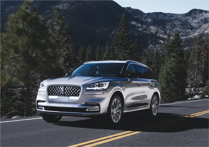 A 2023 Lincoln Aviator® Grand Touring SUV being driven on a winding road to demonstrate the capabilities of all-wheel drive | Casa Lincoln in El Paso TX