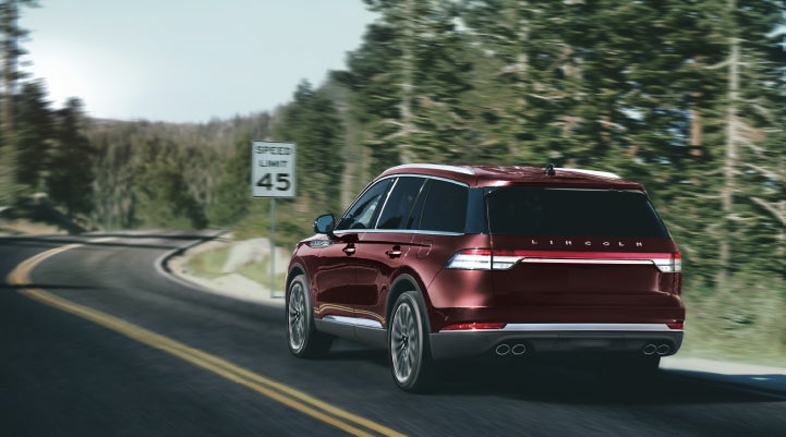 A 2024 Lincoln Aviator® SUV is being driven on a winding mountain road | Casa Lincoln in El Paso TX