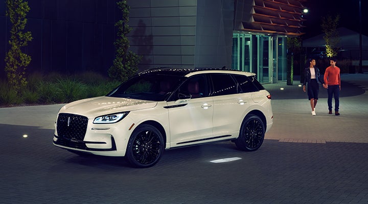 Two people approach a 2024 Lincoln Corsair® SUV featuring the available Jet Appearance Package. | Casa Lincoln in El Paso TX