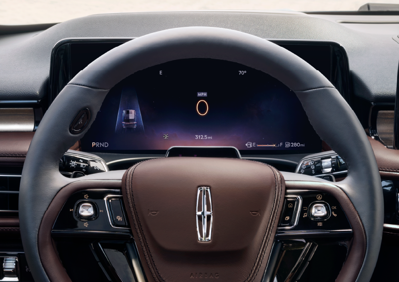 The steering wheel of 2025 Lincoln Aviator® SUV is shown with black and brown accents. | Casa Lincoln in El Paso TX