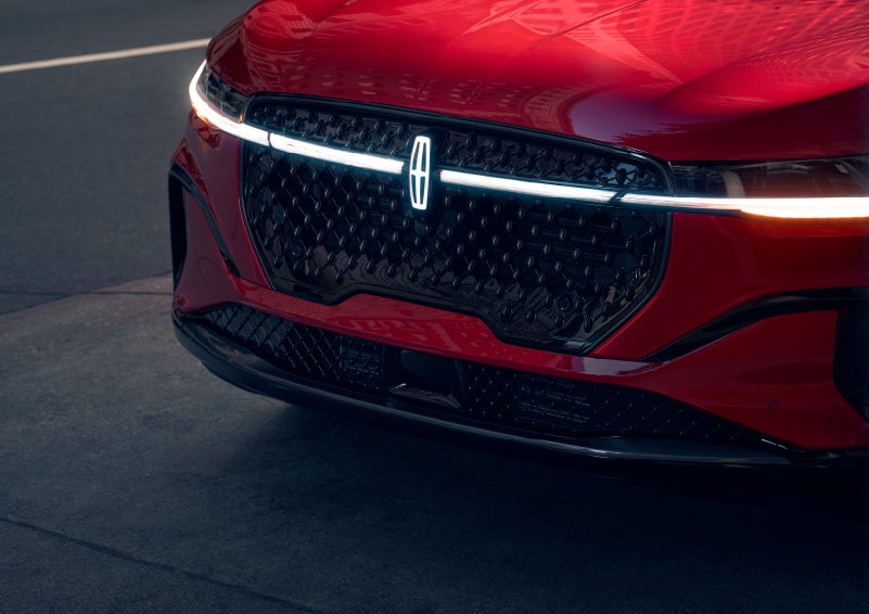 The available front LED light bar and center Lincoln Star logo glow at dusk. | Casa Lincoln in El Paso TX