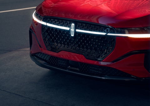 The available front LED light bar and center Lincoln Star logo glow at dusk. | Casa Lincoln in El Paso TX