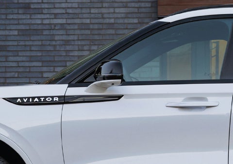 The driver’s side door and fender badging of a white 2026 Lincoln Aviator® SUV are showcased. | Casa Lincoln in El Paso TX