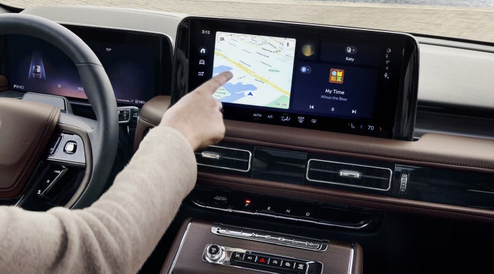 A person is tapping the center display touchscreen of a 2026 Lincoln Aviator® SUV. | Casa Lincoln in El Paso TX