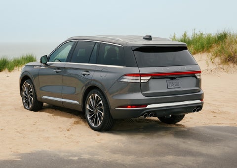 A 2027 Lincoln Aviator® SUV is parked next to sand dunes. | Casa Lincoln in El Paso TX