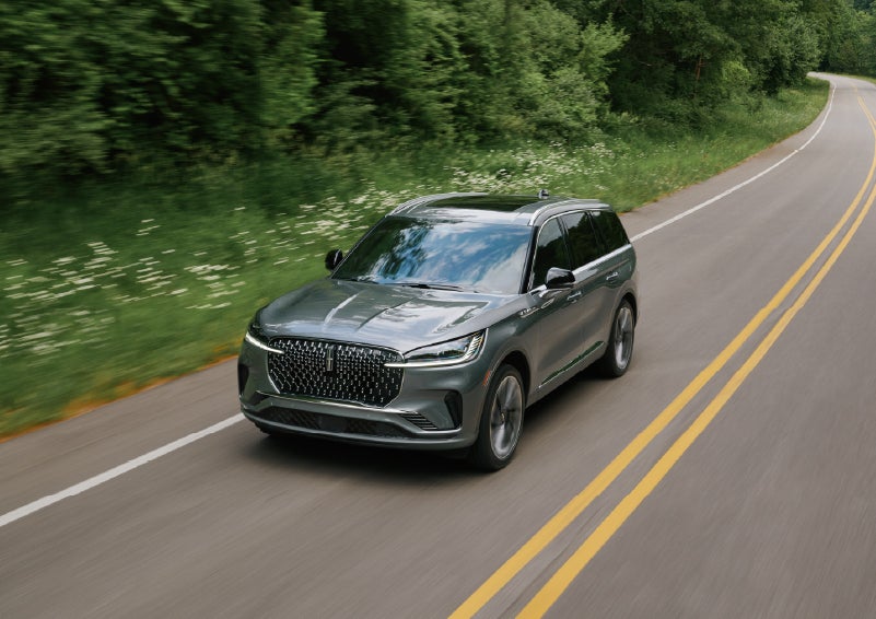 A 2027 Lincoln Aviator® SUV is being driven down a road. | Casa Lincoln in El Paso TX