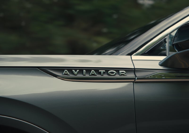 The driver’s side door and fender badging of a gray 2027 Lincoln Aviator® SUV are showcased. | Casa Lincoln in El Paso TX