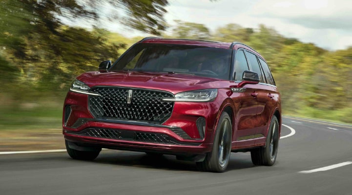 A 2027 Lincoln Aviator® SUV is being driven on a country road | Casa Lincoln in El Paso TX