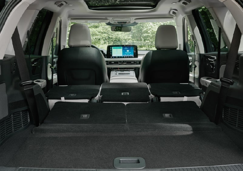 A rear to front view of the interior of a 2027 Lincoln Aviator® Black Label™ SUV shows the third and second rows folded flat | Casa Lincoln in El Paso TX