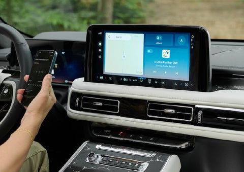 A person pairs thier phone with the center touchscreen of a 2027 Lincoln Aviator® Black Label™ SUV | Casa Lincoln in El Paso TX