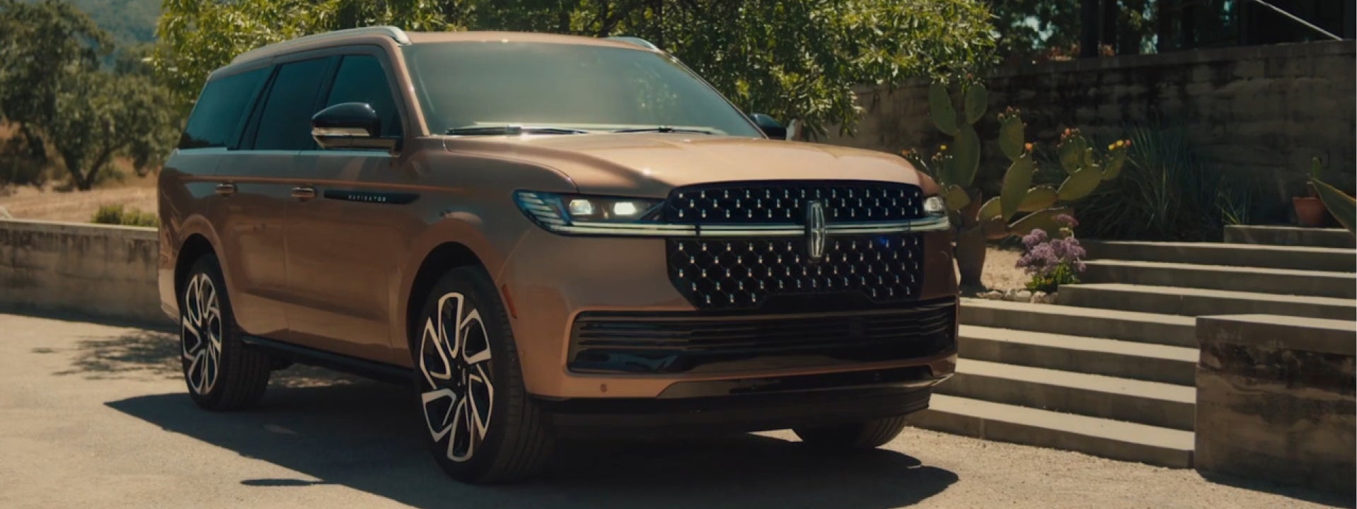 Bronze Lincoln Navigator parked next to steps