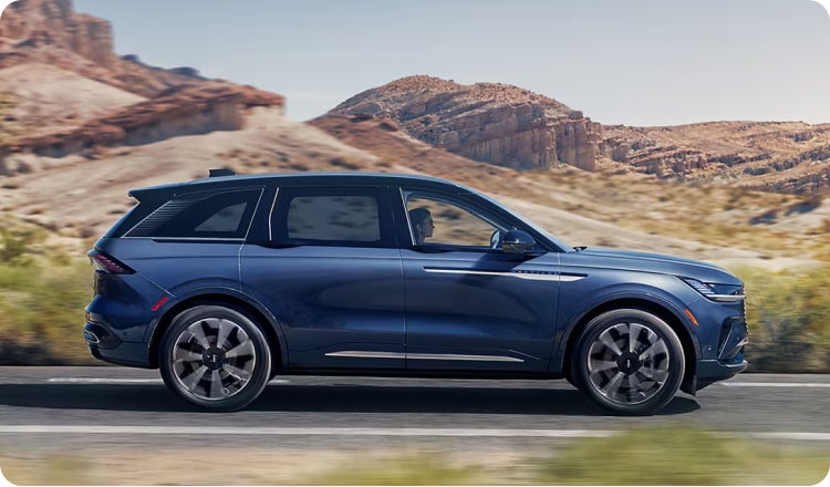 Blue Lincoln SUV driving on the highway